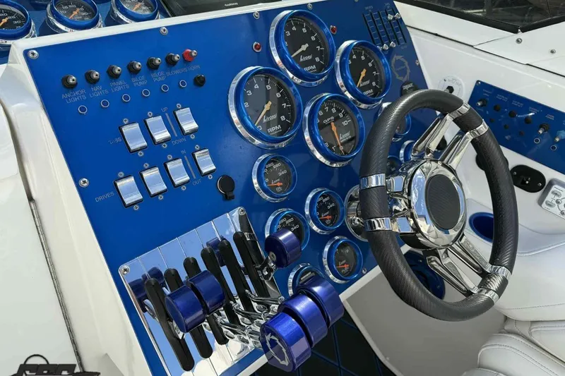 Slide: The Image of Control panel of a 2006 Fountain 47 Lightning boat with gauges and steering wheel. - 29