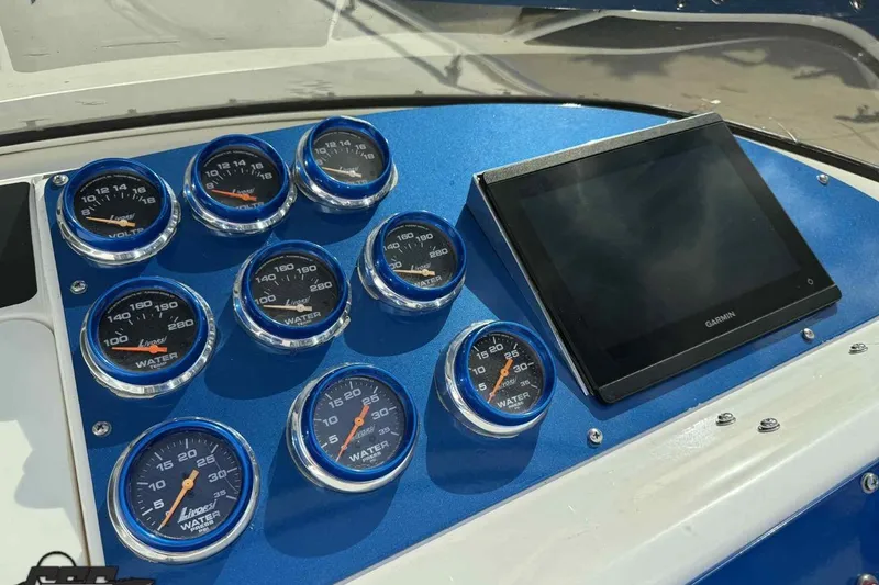 Slide: The Image of Dashboard of 2006 Fountain 47 Lightning boat with gauges and Garmin display. - 32