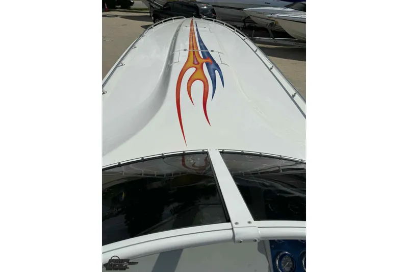 Slide: The Image of 2006 Fountain 47 Lightning boat with vibrant flame graphics on deck. - 33