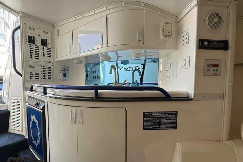 Slide: The Image of 2006 Fountain 47 Lightning boat interior with kitchenette and control panels. - 38