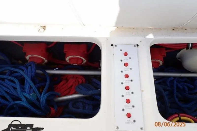 Slide: The Image of Control panel and storage area of a 2006 Fountain 47 Lightning boat with ropes and switches. - 45
