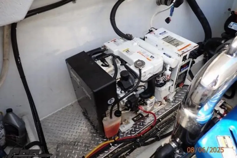 Slide: The Image of Engine compartment of a 2006 Fountain 47 Lightning boat, showing mechanical components and wiring. - 52