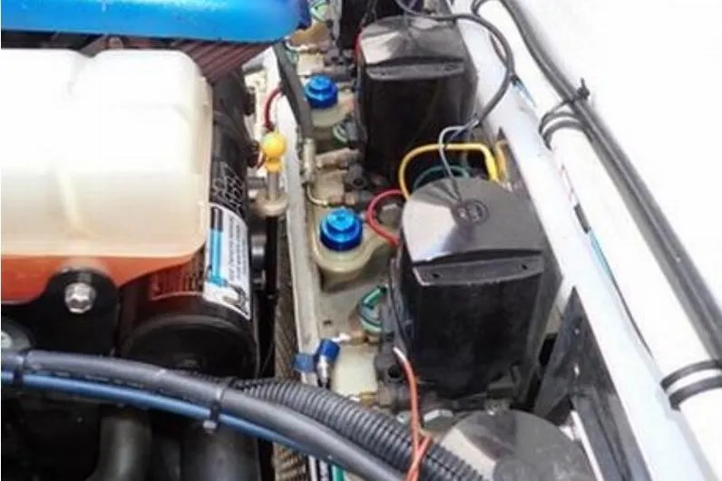 Slide: The Image of Engine compartment of a 2006 Fountain 47 Lightning boat, showcasing wiring and components. - 55