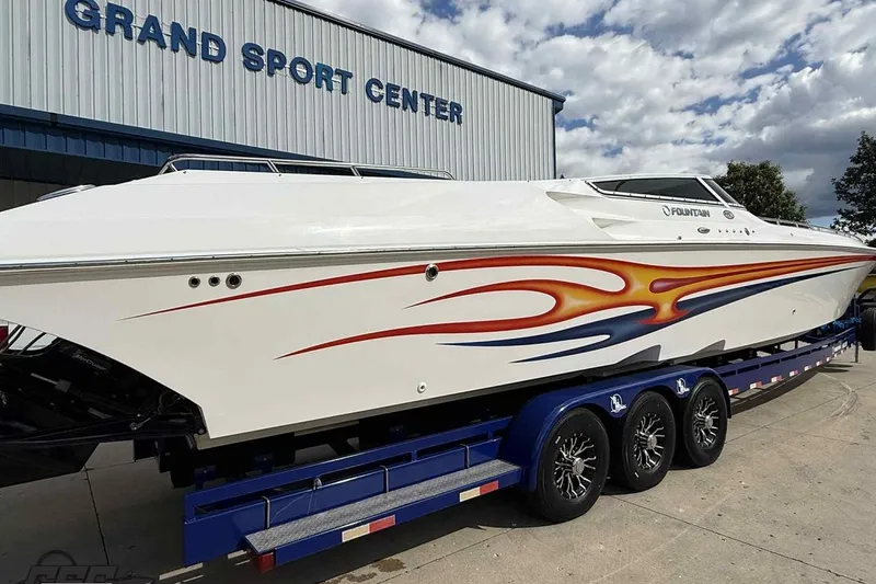 Slide: The Image of 2006 Fountain 47 Lightning speedboat with vibrant graphics at Grand Sport Center. - 6