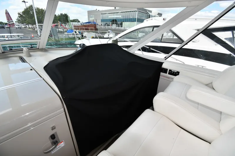 Slide: The Image of 2005 Sea Ray 390 Motor Yacht interior with covered dashboard and white seating. - 10