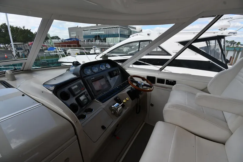 Slide: The Image of 2005 Sea Ray 390 Motor Yacht helm with modern controls and comfortable seating. - 12