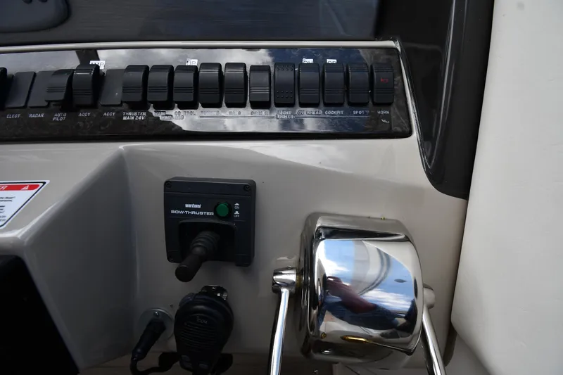 Slide: The Image of Control panel of 2005 Sea Ray 390 Motor Yacht with switches and bow thruster. - 15
