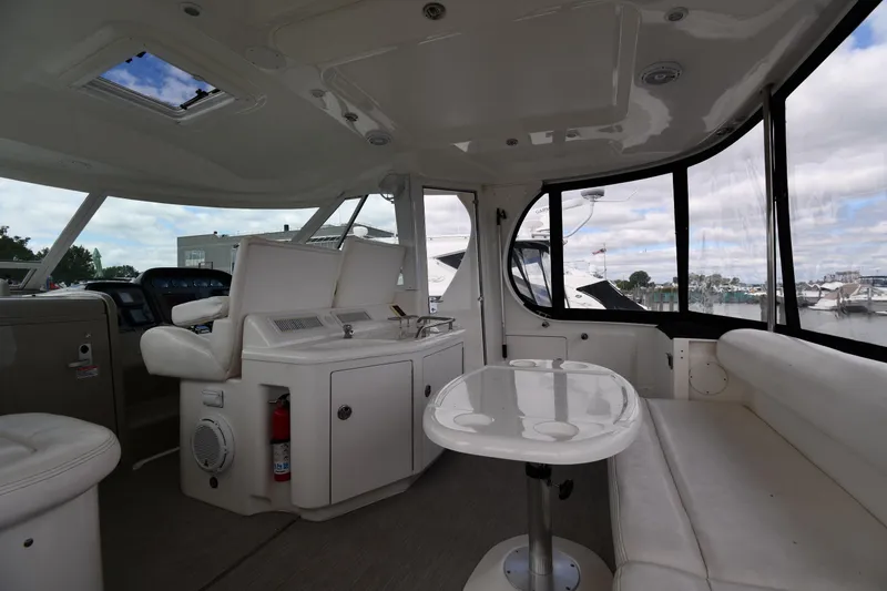 Slide: The Image of Interior of 2005 Sea Ray 390 Motor Yacht with seating and table, docked at marina. - 17