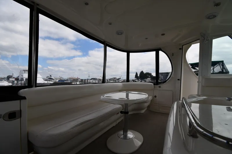 Slide: The Image of Interior of 2005 Sea Ray 390 Motor Yacht with panoramic windows and seating area. - 19