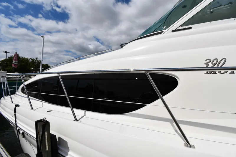 Slide: The Image of 2005 Sea Ray 390 Motor Yacht docked, showcasing sleek design and modern features. - 2