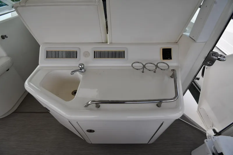 Slide: The Image of 2005 Sea Ray 390 Motor Yacht wet bar with sink and cup holders. - 22