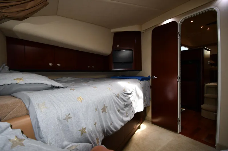 Slide: The Image of Luxurious 2005 Sea Ray 390 Motor Yacht bedroom with cozy bedding and elegant wood finishes. - 31