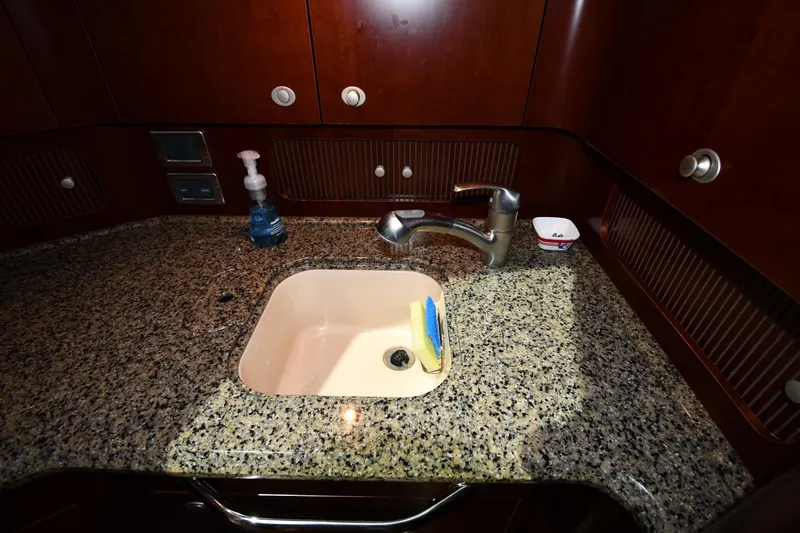 Slide: The Image of Luxurious 2005 Sea Ray 390 Motor Yacht kitchen sink with granite countertop. - 44