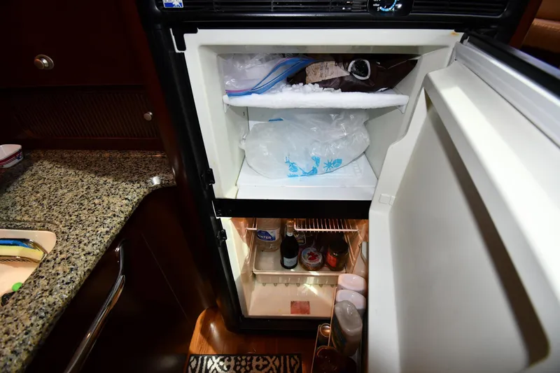 Slide: The Image of Open refrigerator in 2005 Sea Ray 390 Motor Yacht kitchen, showing ice and beverages. - 47