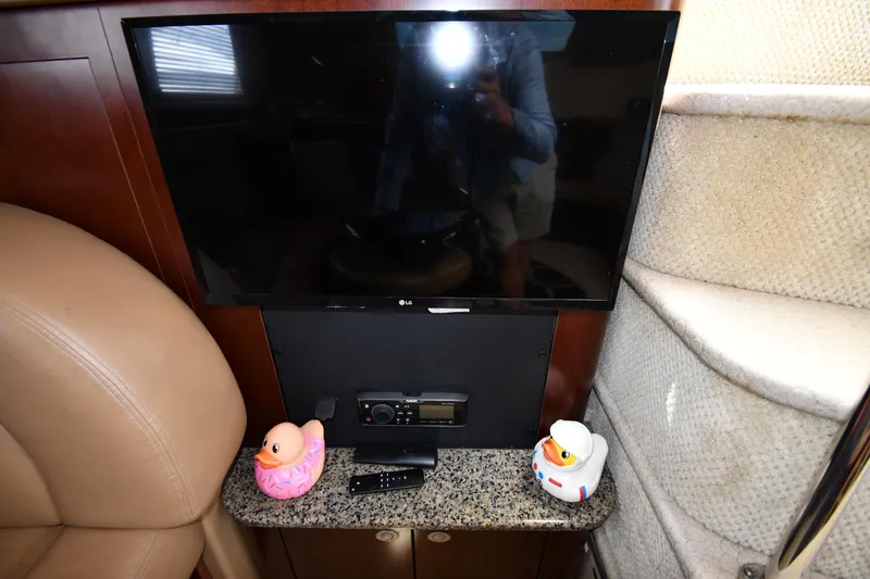Slide: The Image of 2005 Sea Ray 390 Motor Yacht interior with TV, rubber ducks, and granite surface. - 48
