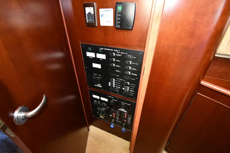 Slide: The Image of 2005 Sea Ray 390 Motor Yacht electrical control panel with wooden finish. - 49