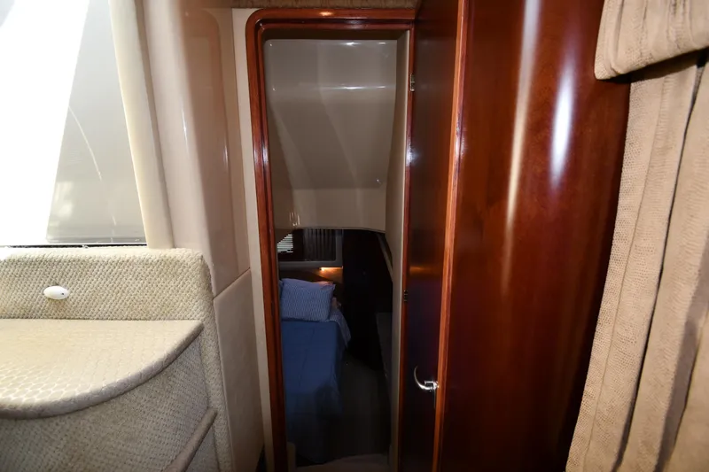 Slide: The Image of Interior view of 2005 Sea Ray 390 Motor Yacht cabin with wooden door and cozy bed. - 50
