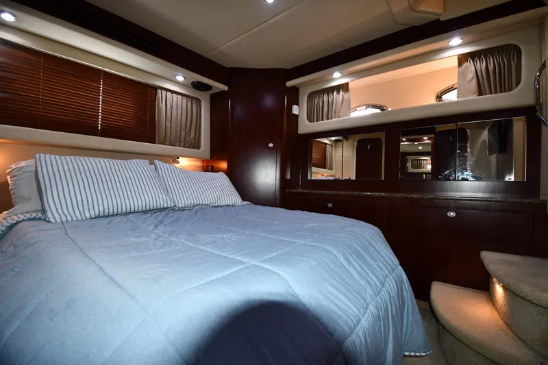 Slide: The Image of Luxurious bedroom interior of 2005 Sea Ray 390 Motor Yacht with elegant wood finishes. - 51