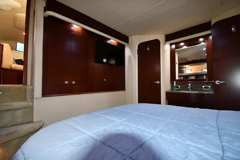 Slide: The Image of Luxurious interior of 2005 Sea Ray 390 Motor Yacht with wood cabinetry and cozy bedding. - 53