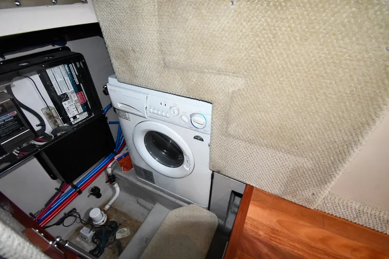 Slide: The Image of Laundry area in 2005 Sea Ray 390 Motor Yacht with washer and electrical panel. - 58