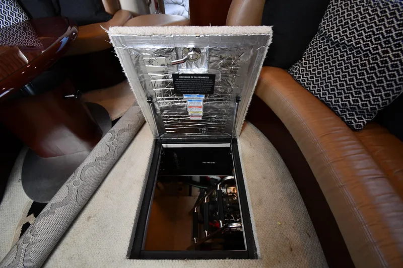 Slide: The Image of 2005 Sea Ray 390 Motor Yacht interior with open engine access hatch. - 59