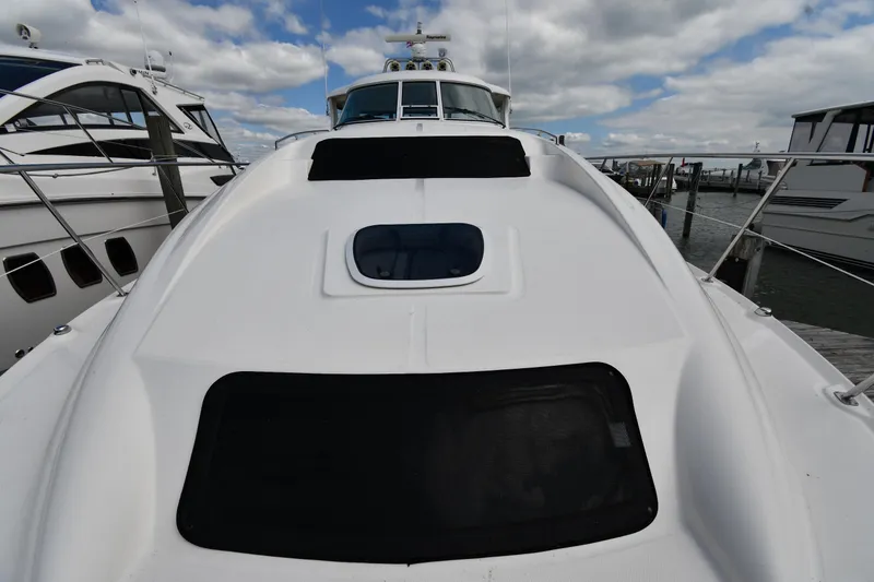 Slide: The Image of 2005 Sea Ray 390 Motor Yacht docked under cloudy sky. - 8