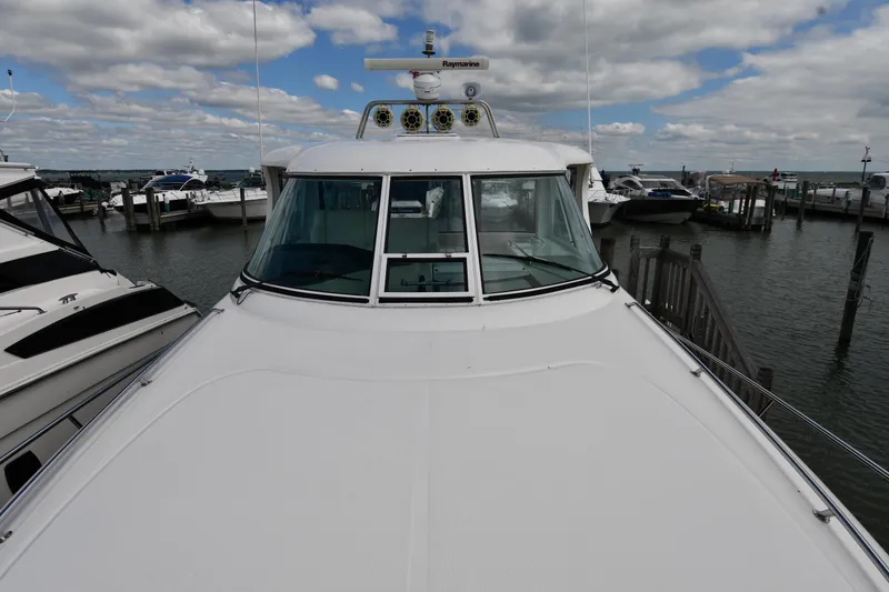 Slide: The Image of 2005 Sea Ray 390 Motor Yacht docked at marina under cloudy sky. - 9