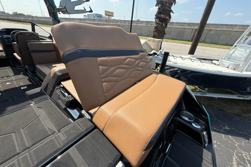 Slide: The Image of 2026 Supra SE 550 boat interior with tan leather seating and cup holders. - 10