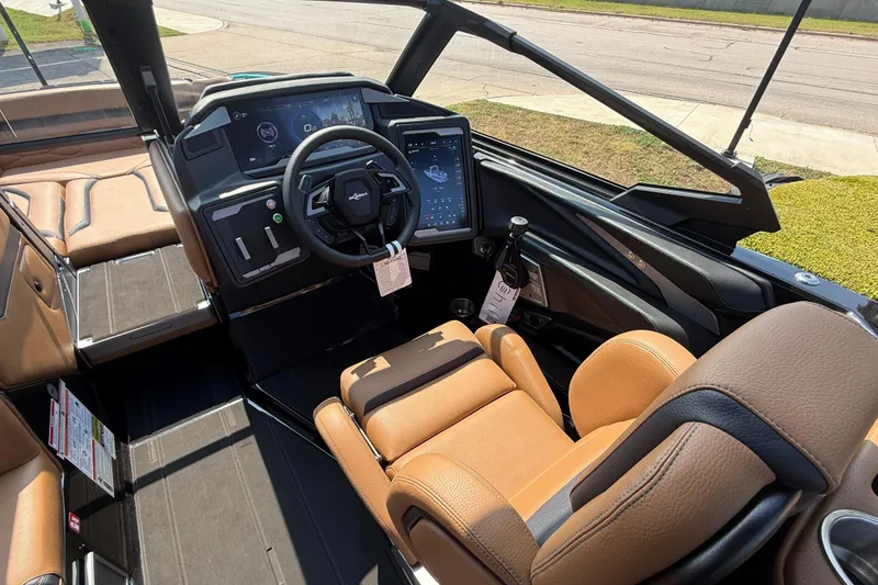 Slide: The Image of 2026 Supra SE 550 boat interior with modern dashboard and tan leather seating. - 11