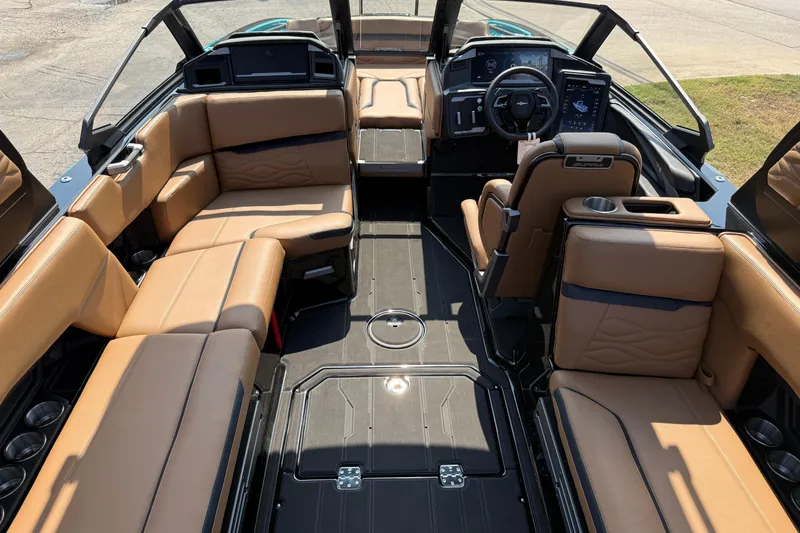 Slide: The Image of Luxurious interior of 2026 Supra SE 550 boat with tan leather seating and modern dashboard. - 12