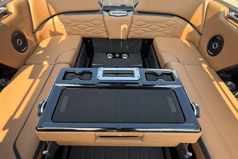Slide: The Image of Luxurious interior of 2026 Supra SE 550 boat with tan leather seating and modern amenities. - 14