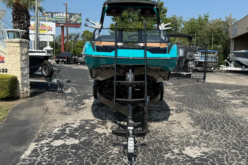 Slide: The Image of 2026 Supra SE 550 boat on trailer in outdoor dealership lot. - 5