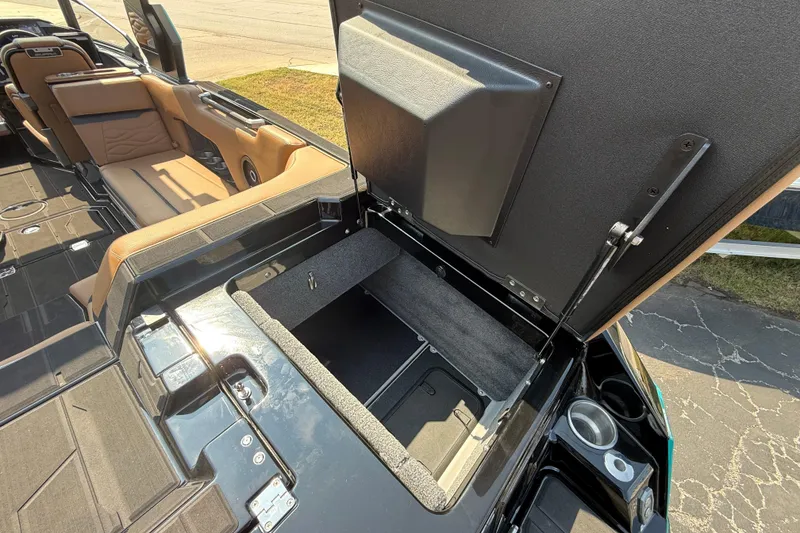 Slide: The Image of 2026 Supra SE 550 boat interior with open storage compartment and tan seating. - 9