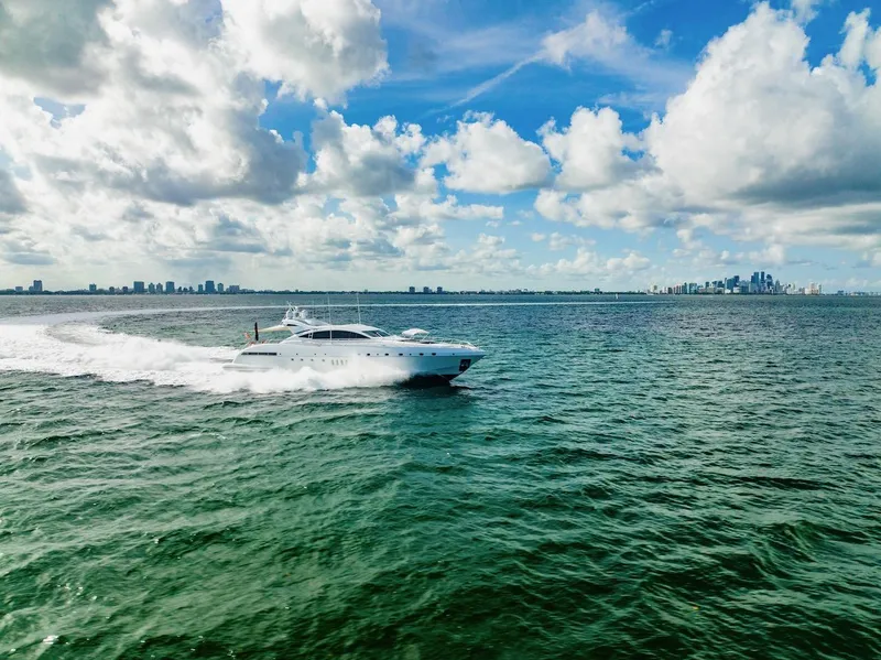 Slide: The Image of Mangusta 92 yacht cruising on open water under a partly cloudy sky, 2007 model. - 20