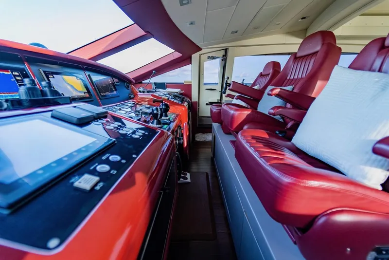 Slide: The Image of Luxurious 2007 Mangusta 92 yacht cockpit with red leather seats and advanced navigation controls. - 28