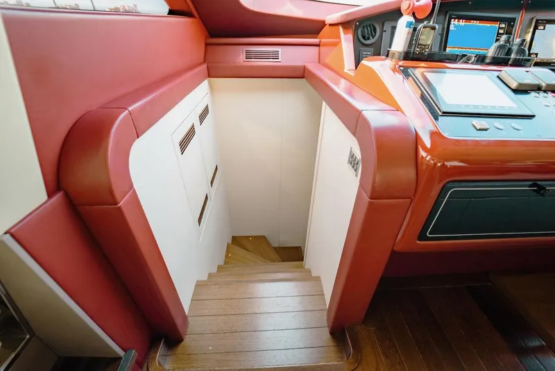 Slide: The Image of Interior of 2007 Mangusta 92 yacht with red and white design, featuring a staircase. - 31