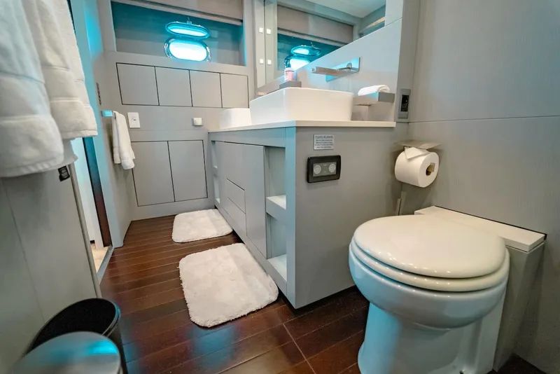 Slide: The Image of Luxurious bathroom in a 2007 Mangusta 92 yacht with modern fixtures and wooden flooring. - 38