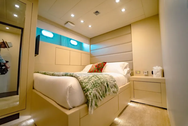 Slide: The Image of Luxurious bedroom interior on a 2007 Mangusta 92 yacht, featuring modern design and cozy bedding. - 46