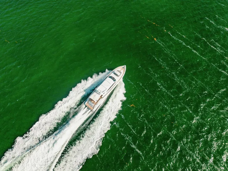 Slide: The Image of Mangusta 92 yacht cruising on vibrant green water, aerial view, 2007 model. - 5