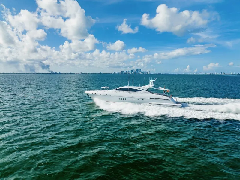 Slide: The Image of Luxury 2007 Mangusta 92 yacht cruising on open sea under blue sky. - 6