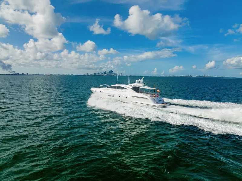 Slide: The Image of Luxury Mangusta 92 yacht cruising on open water under a clear blue sky, 2007 model. - 7