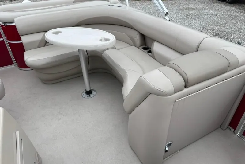 Slide: The Image of 2017 Starcraft EX 20 RDP boat interior with beige seating and round table. - 10
