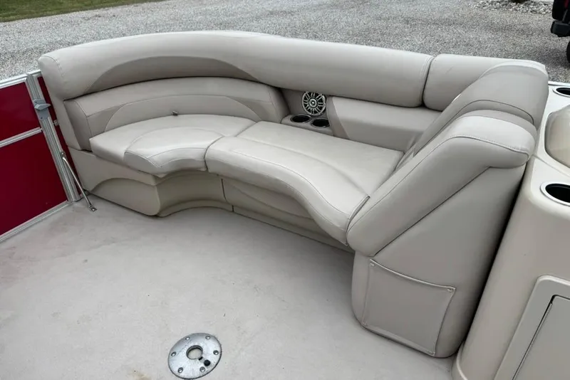 Slide: The Image of 2017 Starcraft EX 20 RDP pontoon boat interior with beige seating and cup holders. - 14