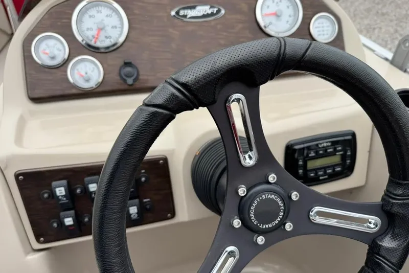 Slide: The Image of Steering wheel and dashboard of 2017 Starcraft EX 20 RDP boat with gauges and controls. - 17