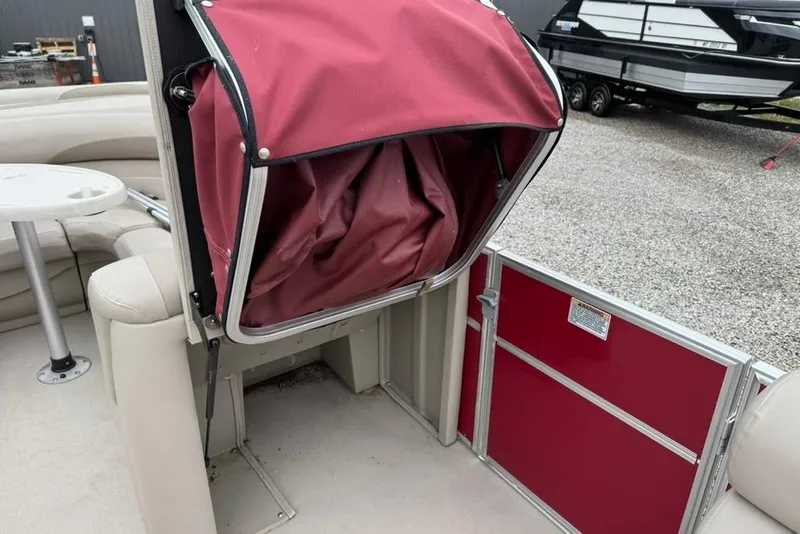Slide: The Image of 2017 Starcraft EX 20 RDP boat interior with red storage compartment and seating area. - 19