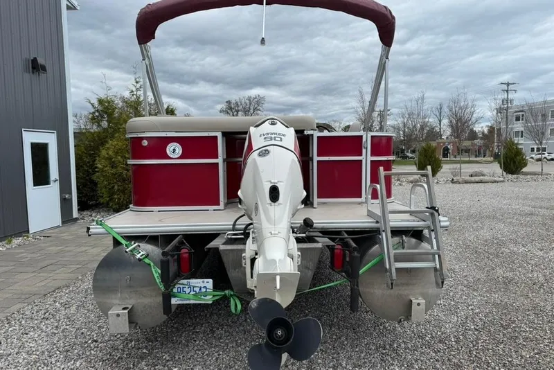 Slide: The Image of 2017 Starcraft EX 20 RDP pontoon boat with Evinrude motor, parked on gravel. - 5