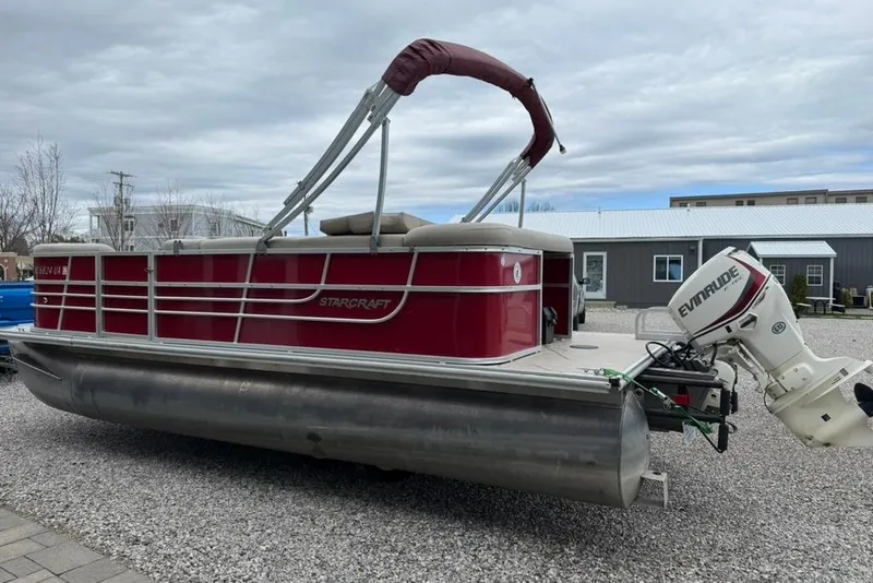 Slide: The Image of 2017 Starcraft EX 20 RDP pontoon boat with Evinrude motor, parked on gravel. - 7