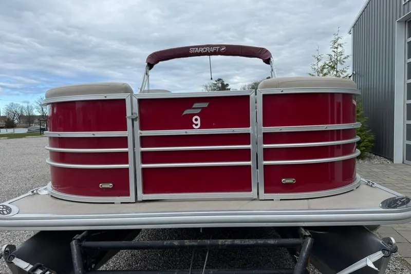 Slide: The Image of 2017 Starcraft EX 20 RDP pontoon boat with red exterior, parked outdoors. - 9