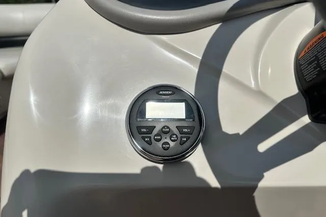 Slide: The Image of 2017 Manitou 23 Oasis dashboard with Jensen audio system controls. - 11