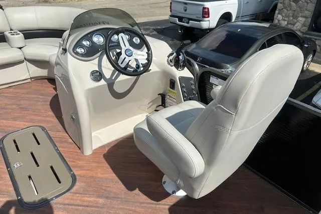 Slide: The Image of 2017 Manitou 23 Oasis boat interior with steering console and seating. - 21